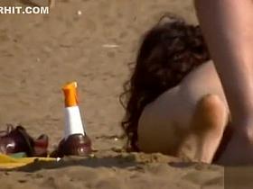 Cute brunette loves to pose on the beach