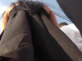 Voyeuring under a hot brunette's skirt