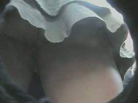 Sexy girl watches the show while voyeur watches upskirt ass