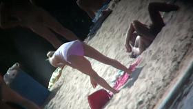 Beach voyeur vid features a hot blonde topless girl.