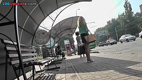 Blonde waits for a bus in the upskirt outdoor scene