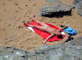 Nude girl on beach sunning.