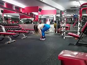 Fitness babe wearing tight blue sports pants