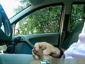 Guy plays with his cock inside car