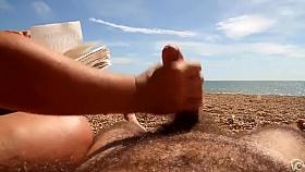 Reading the book and stroking the erected cock