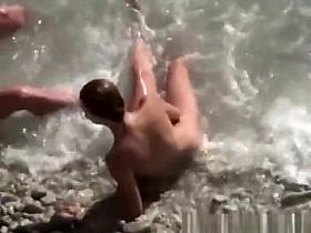 Nude couple enjoying the cool water