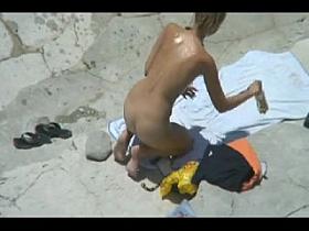 Peeping at a hot nudist couple on the beach