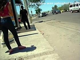 Sexy slutty woman at a bus stop