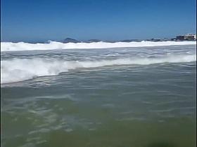 Large-assed harlot wears a flimsy bikini to the beach