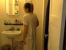 Nurse with her wet uniform in bathroom