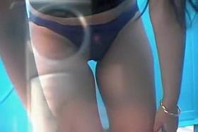 Sweet bimbo is undressing in the change beach cabin