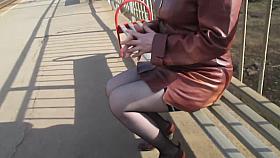 Girl in seamed stockings going upstairs on a train station