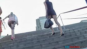 Upskirt tease by raven-haired girl in short dress
