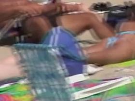 Nicely shaped chick on her belly in beach candid video 04u