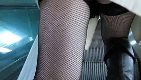 Fishnet stockings upskirt on escalator
