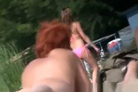 Short hair redhead nudist woman and friend