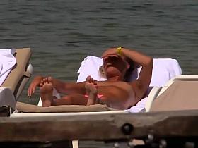 Topless girls relaxing by the beach