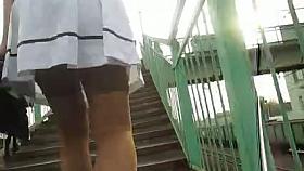 Girl in white skirt and stockings going upstairs 2