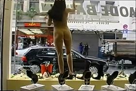 Young flexible looker poses completely naked in the store