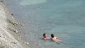 Couple fucked on a public beach while as people walked near