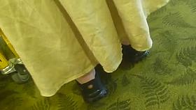 Long dress upskirt of a MILF in the library