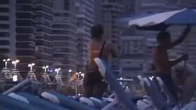 A voyeur films sexy people fucking on the nighttime beach