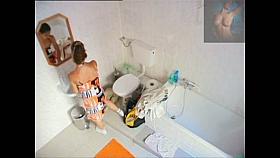 A magnificent brunette takes a piss in a bathroom porno video