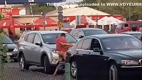 Boy with girl having sex on a car in the bazaar.