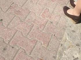 Tan Nylon Feet Play At the Bus Station