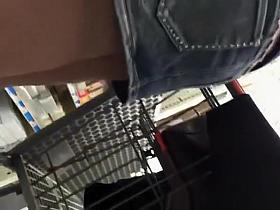 Woman in short jeans skirt upskirted