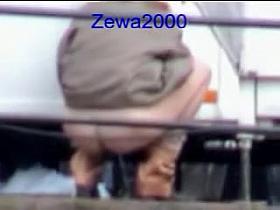 Shameless pissing woman is getting voyeured outdoor