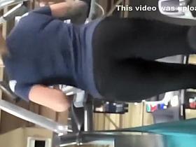 Tattooed woman running in treadmill