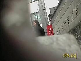 Glamorous Asian babe skirt sharked on a gloomy day.