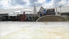 Mature couples walk around the nudist resort completely naked