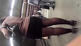 Curvy blonde babe in a tiny black miniskirt is stalked in t