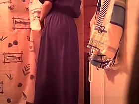 Woman spied in bathroom undressing