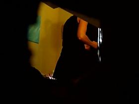 Spy cam film a girl in her dressing room putting on a thong