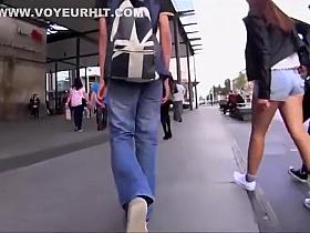 Shy girl tries to pull hot pants down