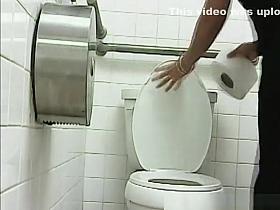 Woman pissing in public toilet