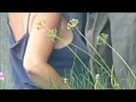 A dude is filming the nice cleavage of a hot babe