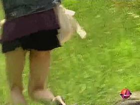 Asian babe texting falls victim to skirt sharking.