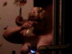 Older nude couple spying through window.