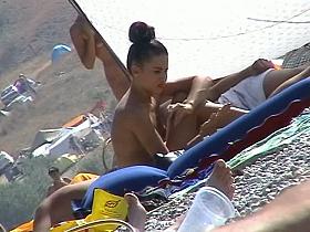 Hot red hair babe takes a nude sunbath at the beach