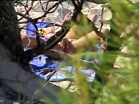 Aroused girl rubbing her pussy on a beach