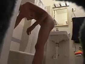 Hot teen caught naked in the bathroom on hidden cam