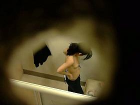 This cute babe is spotted in a changing room with naked boobs