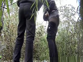 Couple peeing outdoors