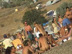 Sexy beach nudist girl spied talking on phone near water