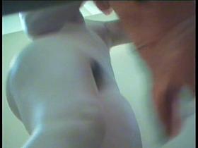 A woman in the sports club is changing her outfit and getting naked