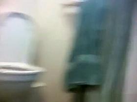 Blonde pissing in toilet